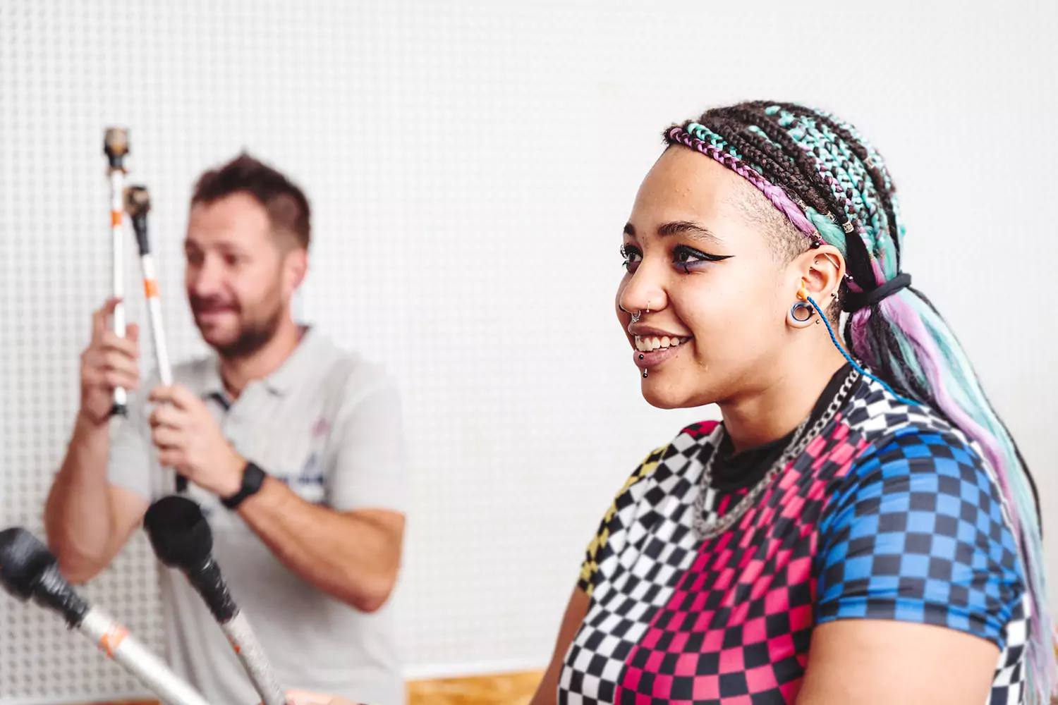 A young woman is smiling while in a group musical class